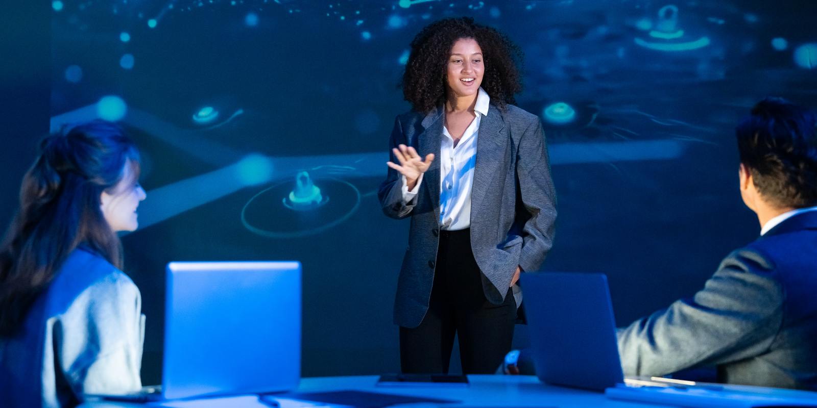A cybersecurity consultant presenting to colleagues in a digital immersive environment representing professional cybersecurity consulting