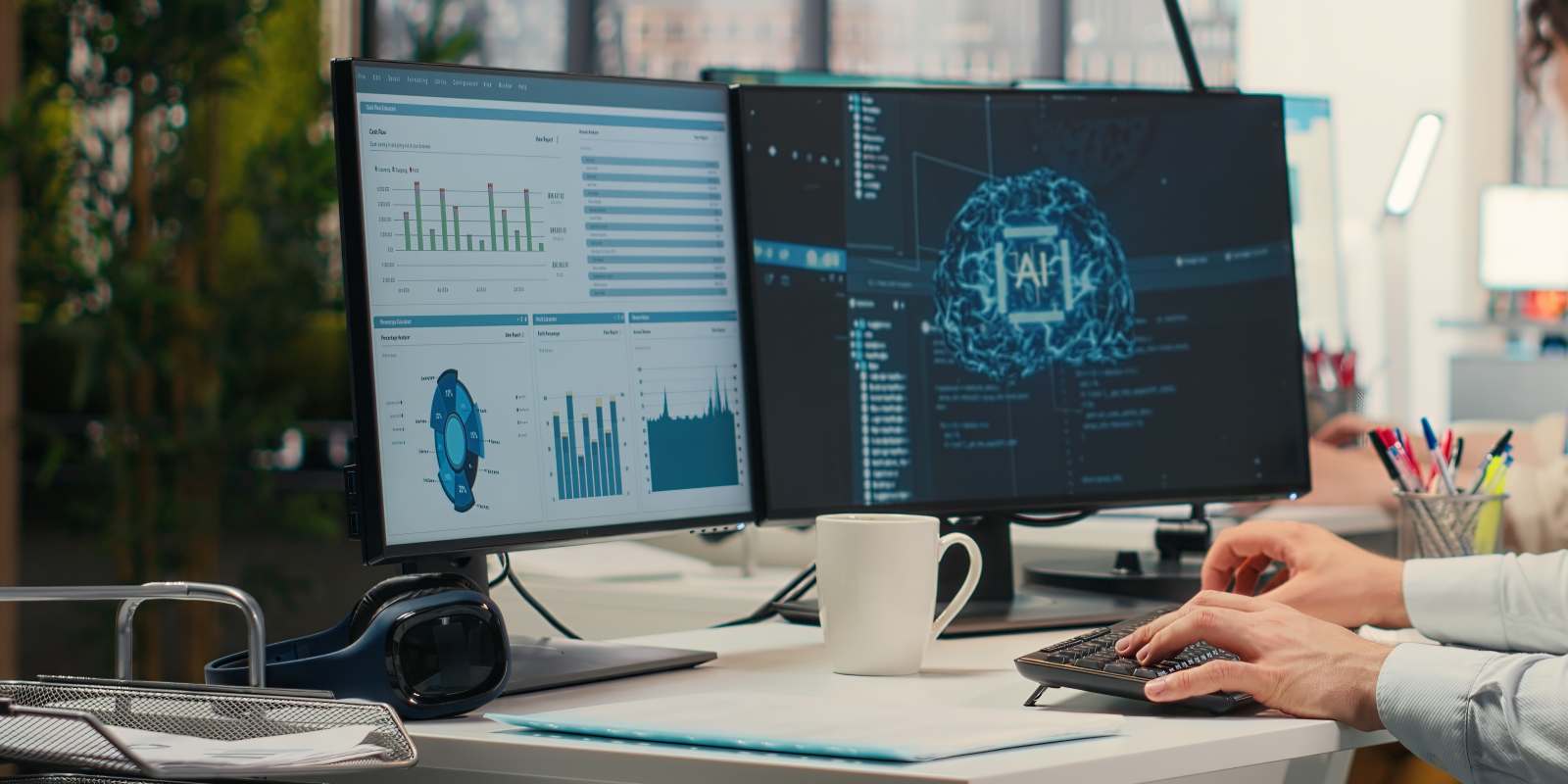 A focused IT specialist monitoring AI and system dashboards on multiple screens in a collaborative office environment representing IT staff augmentation