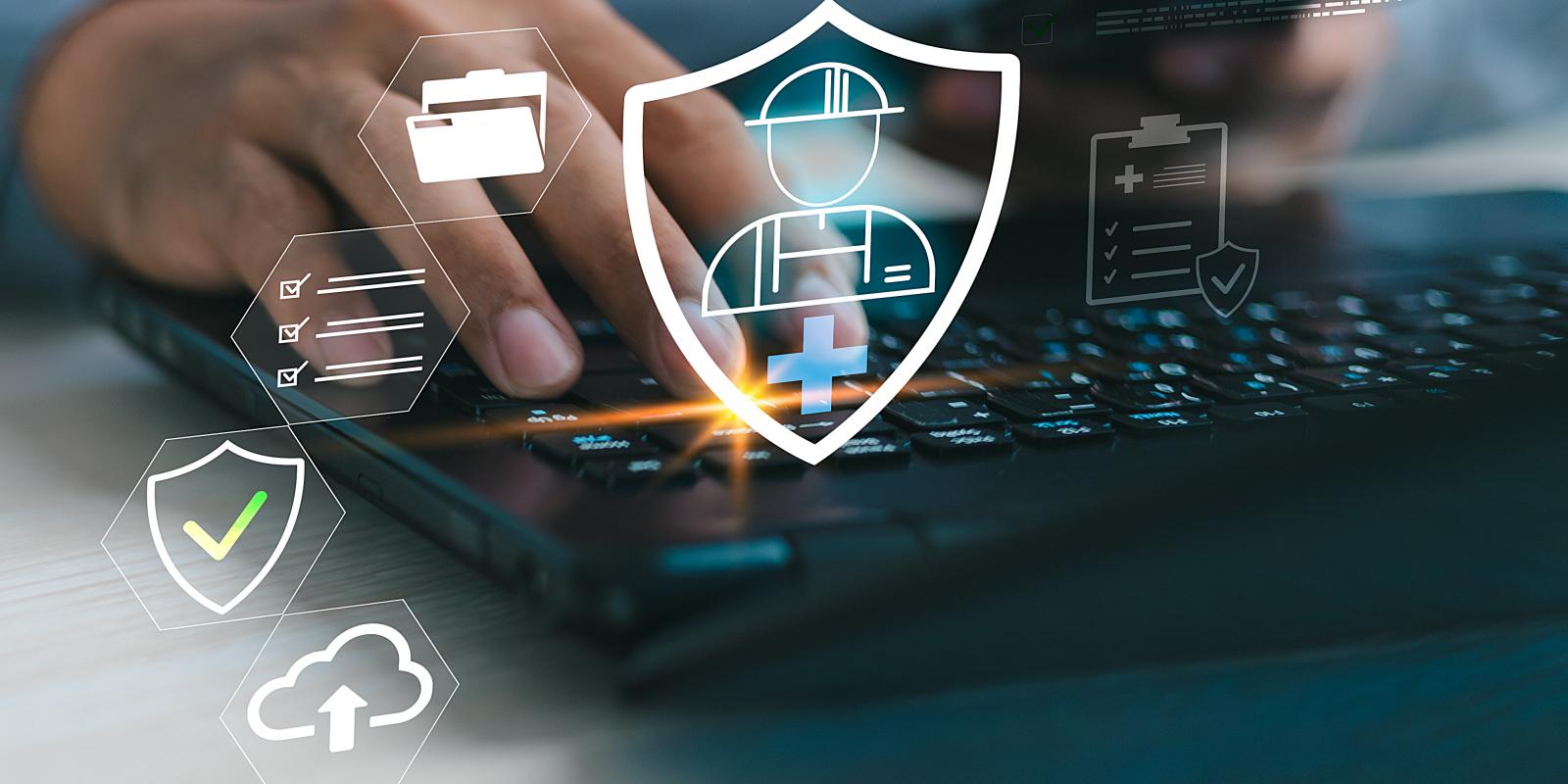 A person typing on a keyboard with digital icons of a shield, checkmark, cloud upload, and document overlays, representing cybersecurity compliance audit