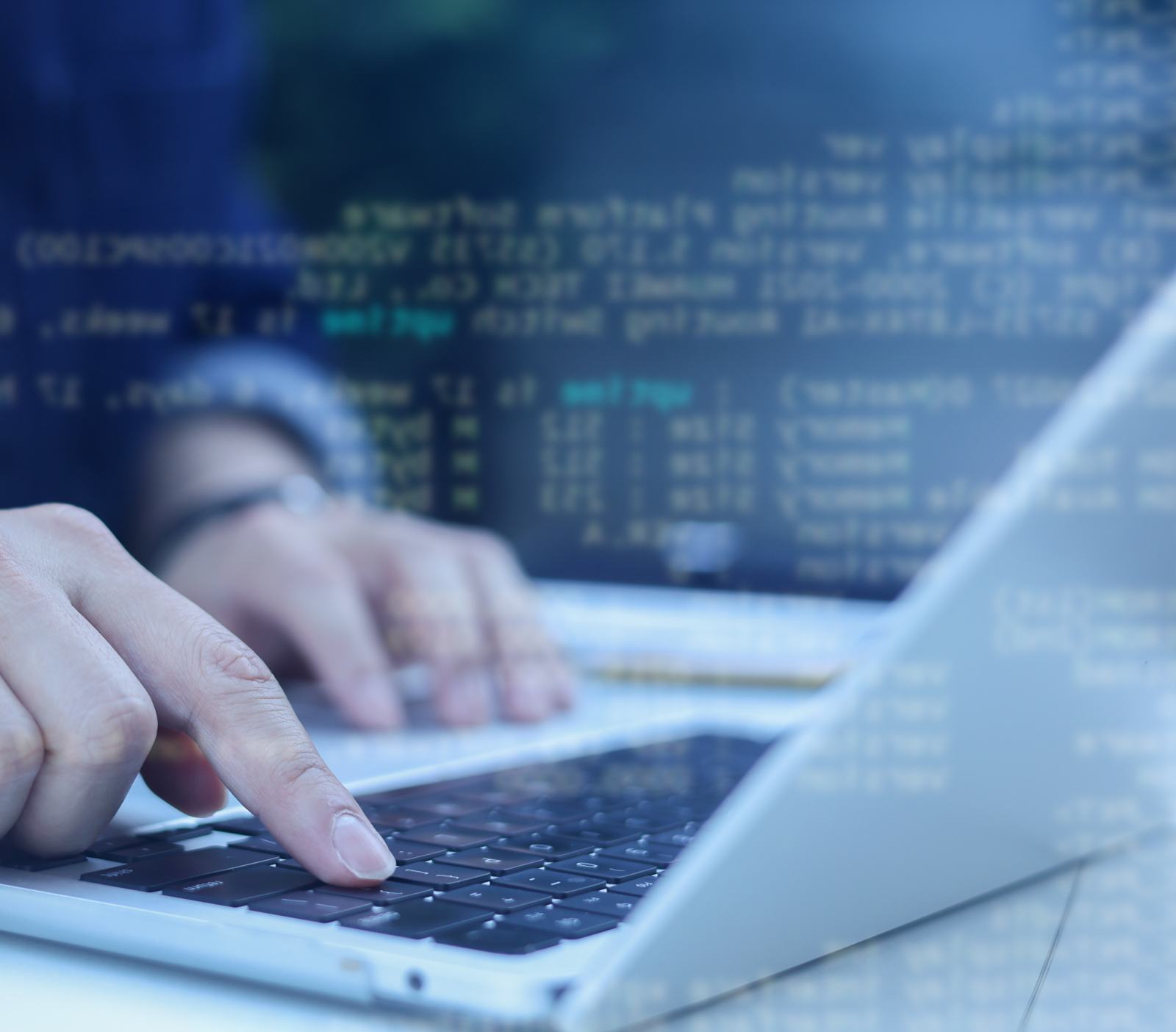 IT security professional typing on a laptop with overlaid code during a vulnerability test