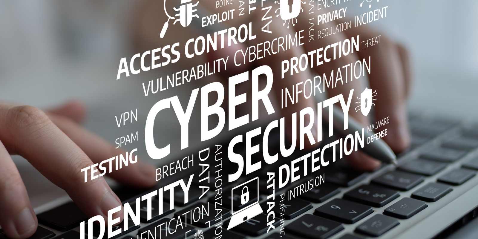 a keyboard overlaid with cybersecurity terms including identity authentication detection and access control representing a knowledgeable and capable cybersecurity workforce
