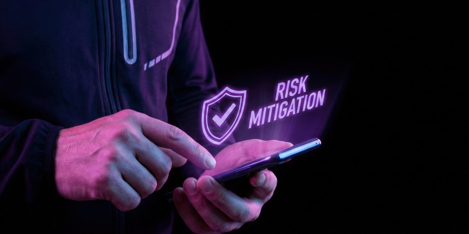 person holding a smartphone with a glowing shield and 'Risk Mitigation' hologram, representing proven cybersecurity risk mitigation